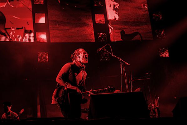 Stained red photograph of Thom Yorke performing onstage